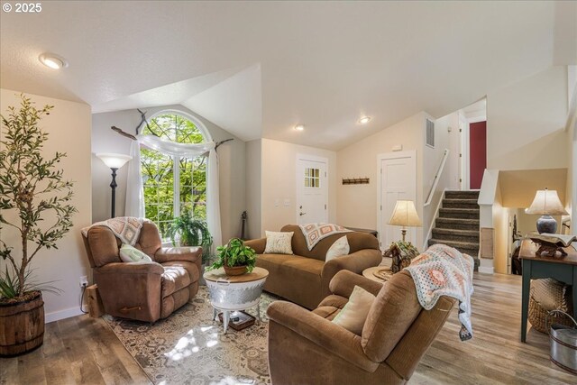 808 SE Beaver Creek Ln, Troutdale, OR 97060 - living room featuring vaulted ceiling, wood finished floors, and stairs