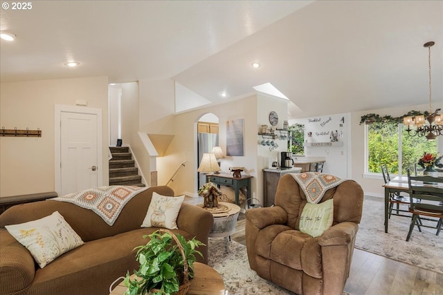 808 SE Beaver Creek Ln, Troutdale, OR 97060 - living room with stairs, wood finished floors, lofted ceiling, a chandelier, and arched walkways