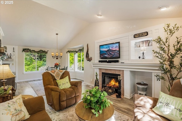 808 SE Beaver Creek Ln, Troutdale, OR 97060 - living room with light wood-style floors, vaulted ceiling, a tiled fireplace, a chandelier, and baseboards