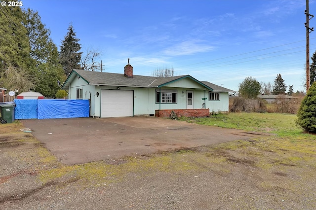 ranch-style home featuring a garage and a front yard