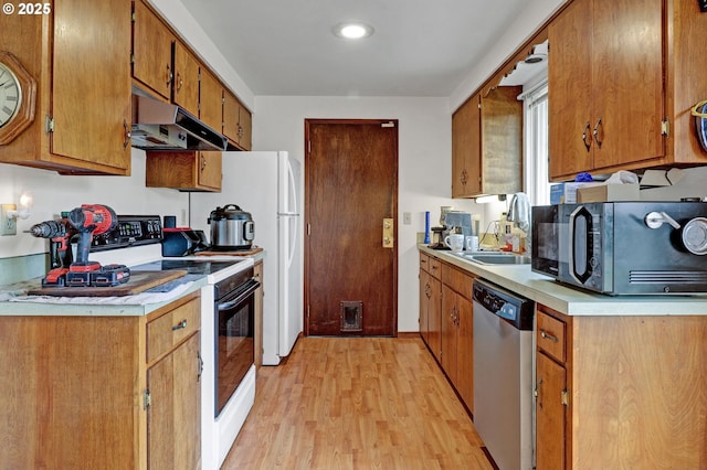 kitchen featuring sink, stainless steel dishwasher, electric range, and light wood-type flooring