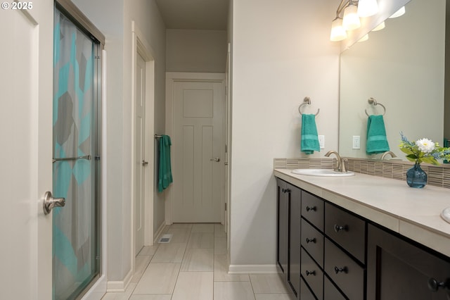 2314 SW 43rd St, Gresham, OR 97080 - bathroom featuring double vanity, a stall shower, tile patterned flooring, and backsplash