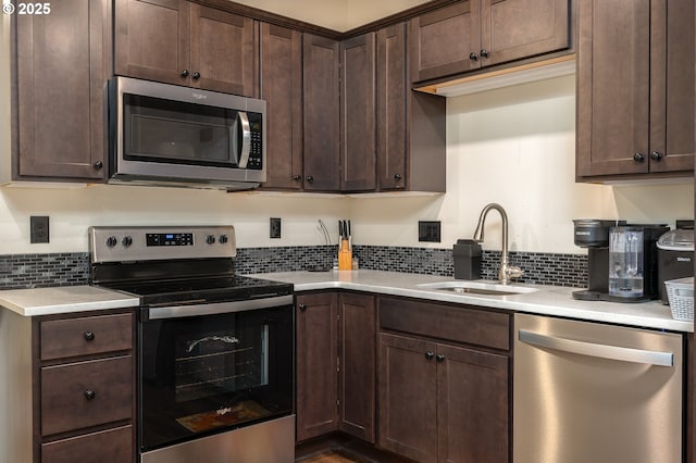 2314 SW 43rd St, Gresham, OR 97080 - kitchen featuring stainless steel appliances, dark brown cabinets, backsplash, and light countertops