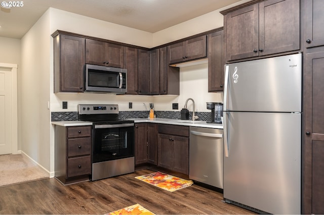 2314 SW 43rd St, Gresham, OR 97080 - kitchen with appliances with stainless steel finishes, dark wood finished floors, dark brown cabinets, and light countertops