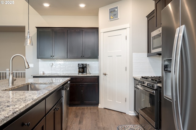 2314 SW 43rd St, Gresham, OR 97080 - kitchen featuring appliances with stainless steel finishes, dark wood-style floors, dark brown cabinets, decorative backsplash, and recessed lighting