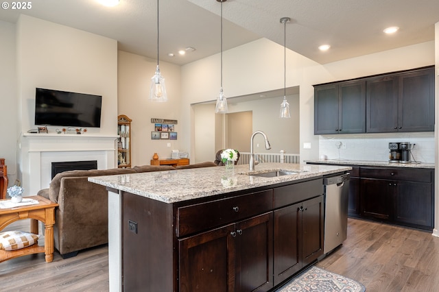 2314 SW 43rd St, Gresham, OR 97080 - kitchen with stainless steel dishwasher, light wood-type flooring, tasteful backsplash, light stone counters, and recessed lighting