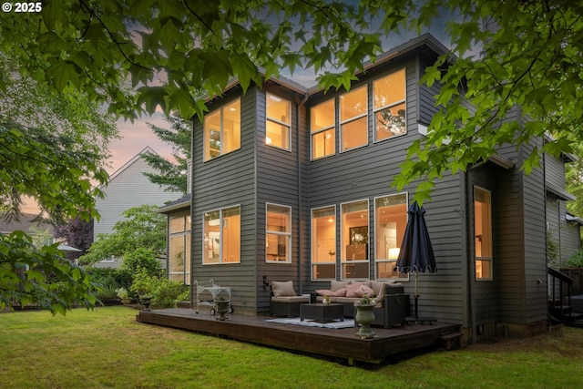 4698 Winthrop Ct, Lake Oswego, OR 97035 - back of property at dusk with outdoor lounge area, a deck, and a lawn