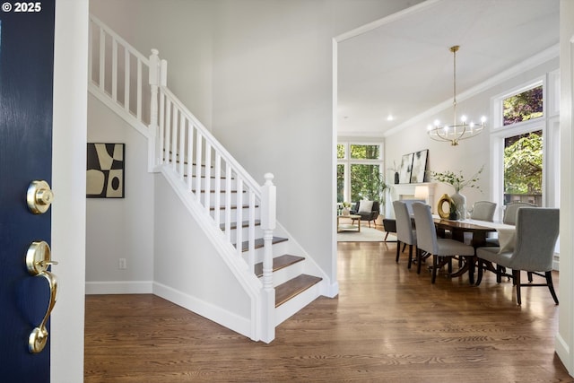 4698 Winthrop Ct, Lake Oswego, OR 97035 - entrance foyer featuring stairway, dark wood-style floors, ornamental molding, and a chandelier