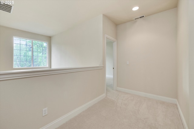 carpeted spare room featuring baseboards and recessed lighting