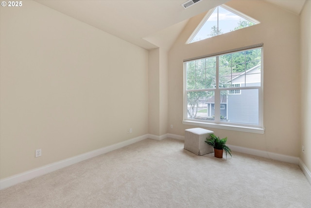 unfurnished room featuring carpet floors, lofted ceiling, and baseboards