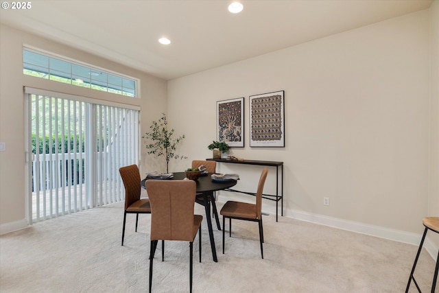 dining area featuring light carpet, baseboards, and recessed lighting