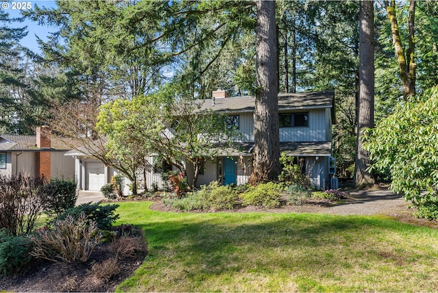 view of front facade with a front lawn and a chimney