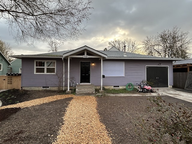 view of front of house with fence, a garage, and driveway