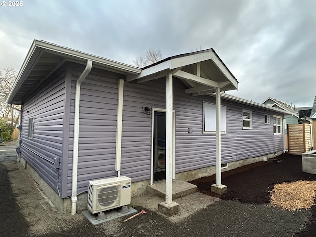 view of side of property featuring ac unit and crawl space