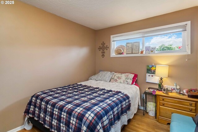772 Elochoman Valley Rd, Cathlamet, WA 98612 - bedroom with wood finished floors, baseboards, and a textured ceiling