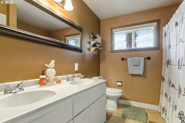 772 Elochoman Valley Rd, Cathlamet, WA 98612 - bathroom featuring toilet, tile patterned flooring, double vanity, baseboards, and a shower with shower curtain