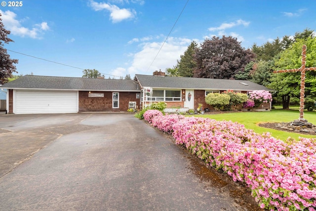 772 Elochoman Valley Rd, Cathlamet, WA 98612 - single story home with asphalt driveway, a chimney, a garage, and a front yard