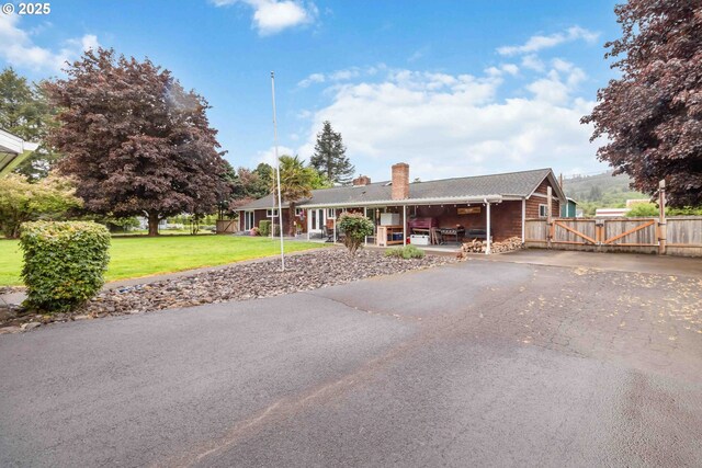 772 Elochoman Valley Rd, Cathlamet, WA 98612 - view of front facade featuring a gate, a chimney, and driveway