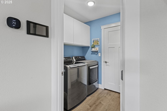 4635 Chaucer Ct, Depoe Bay, OR 97341 - laundry room with washing machine and dryer, light wood finished floors, and cabinet space