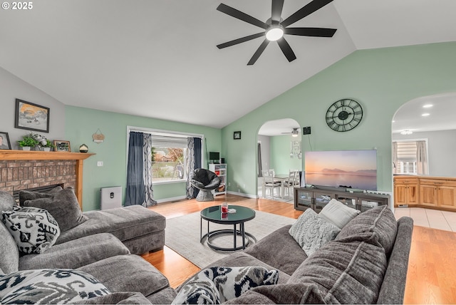 292 Jamie Loop, Roseburg, OR 97471 - living area featuring arched walkways, a ceiling fan, wood finished floors, a brick fireplace, and high vaulted ceiling