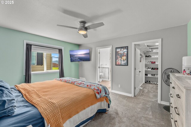 292 Jamie Loop, Roseburg, OR 97471 - bedroom featuring light colored carpet, baseboards, a spacious closet, connected bathroom, and a ceiling fan