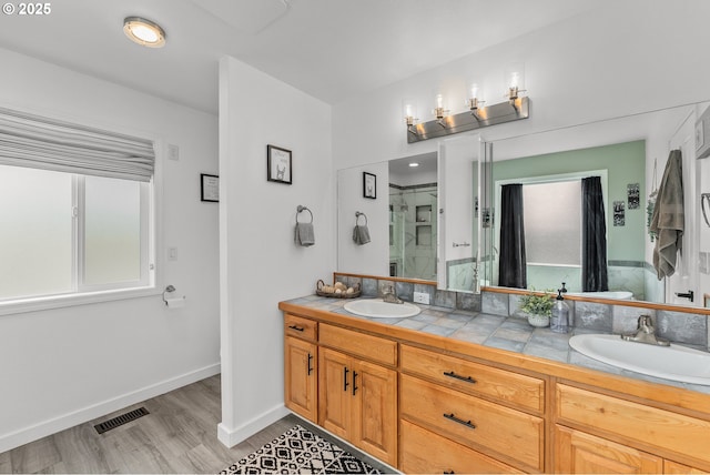 292 Jamie Loop, Roseburg, OR 97471 - bathroom featuring double vanity, wood finished floors, a stall shower, and baseboards
