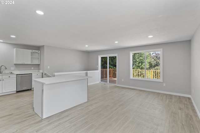 kitchen featuring stainless steel dishwasher, light wood-style floors, recessed lighting, light countertops, and a sink