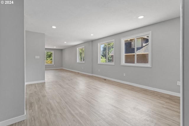 empty room with baseboards, recessed lighting, and a healthy amount of sunlight