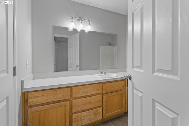 full bath with vanity and a shower