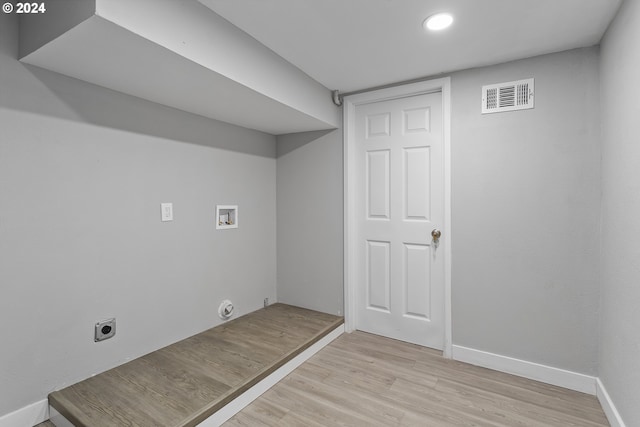 clothes washing area with washer hookup, laundry area, light wood finished floors, electric dryer hookup, and visible vents