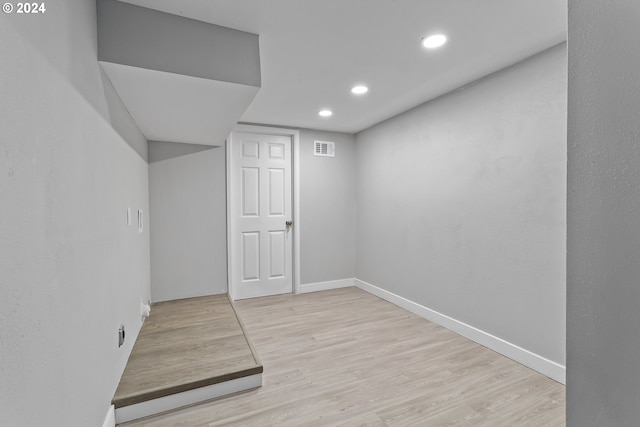 finished basement with baseboards, recessed lighting, wood finished floors, and visible vents