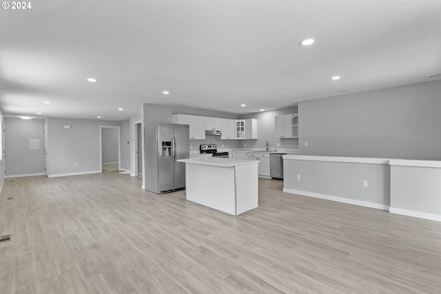 kitchen featuring light countertops, stainless steel appliances, baseboards, and under cabinet range hood