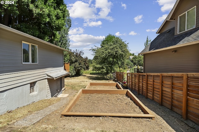 view of yard with fence and a garden