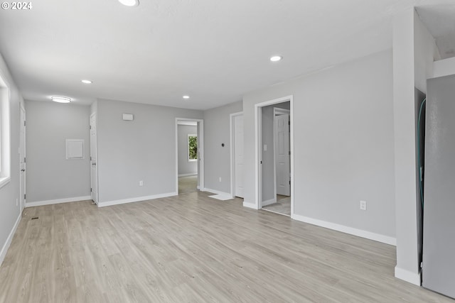 unfurnished living room featuring light wood-style floors, baseboards, and recessed lighting