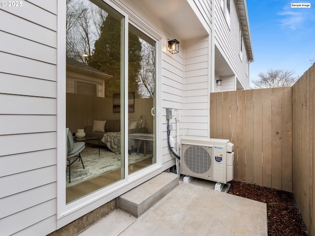 view of patio with ac unit and fence