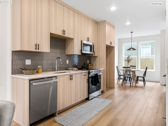 kitchen with stainless steel appliances, visible vents, decorative backsplash, and light countertops