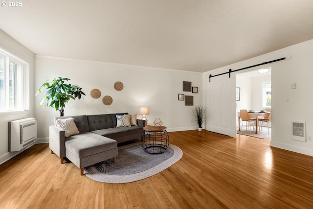 154 Ridgeway Rd, Lake Oswego, OR 97034 - living room with a barn door, light wood-style flooring, baseboards, heating unit, and ornamental molding