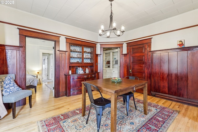 2058 NW Flanders St Unit 5-2, Portland, OR 97209 - living room with a chandelier, wood finished floors, and baseboards
