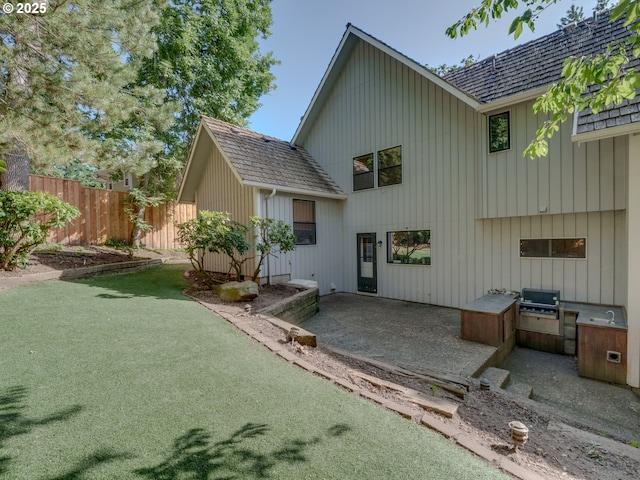 2703 Moon Mountain Dr, Eugene, OR 97403 - back of property featuring area for grilling, a patio area, and board and batten siding