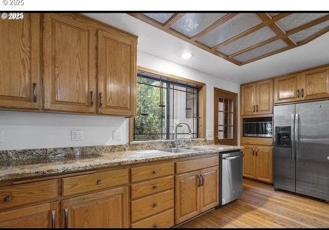 2703 Moon Mountain Dr, Eugene, OR 97403 - kitchen with appliances with stainless steel finishes, brown cabinetry, light wood-style flooring, and recessed lighting