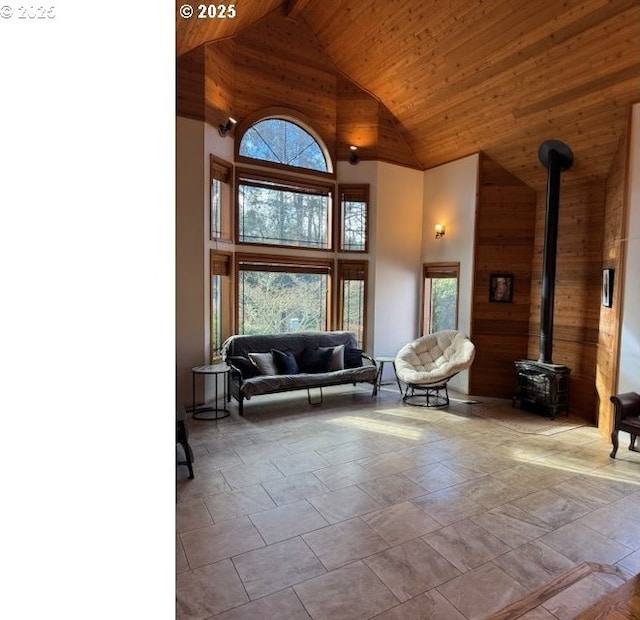 2703 Moon Mountain Dr, Eugene, OR 97403 - living area with wooden ceiling, high vaulted ceiling, a wood stove, healthy amount of natural light, and wooden walls