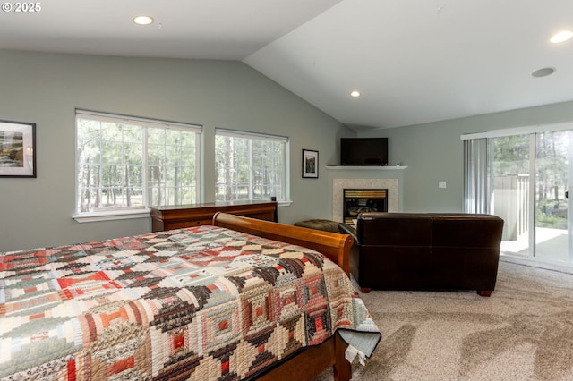 bedroom featuring multiple windows, vaulted ceiling, access to exterior, and carpet