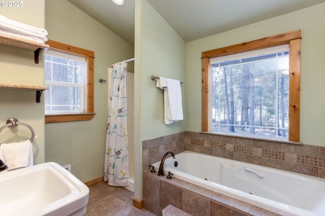 bathroom with sink, tiled bath, vaulted ceiling, and tile patterned floors