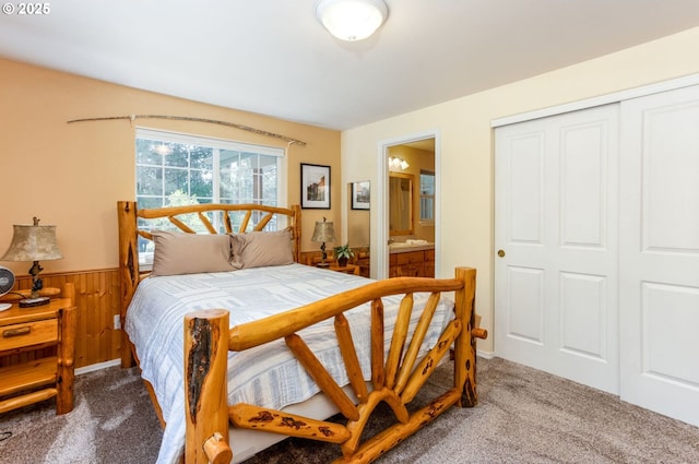 carpeted bedroom with a closet and ensuite bathroom