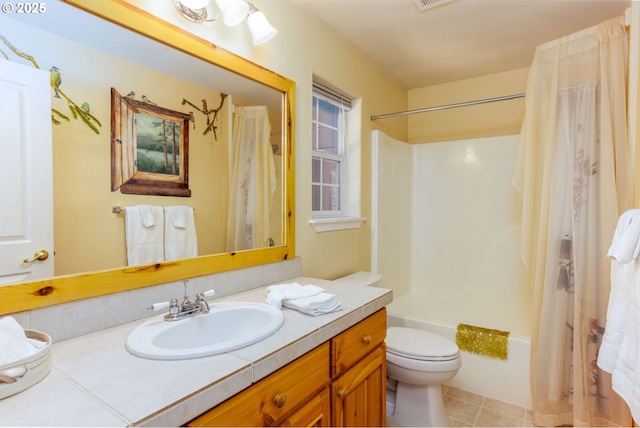 full bathroom featuring vanity, tile patterned flooring, shower / tub combo with curtain, and toilet