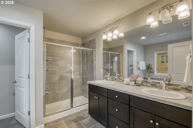 full bathroom featuring a stall shower, a sink, and visible vents