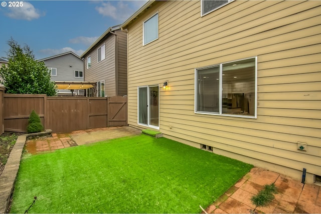 back of house with a patio area, fence, and a yard