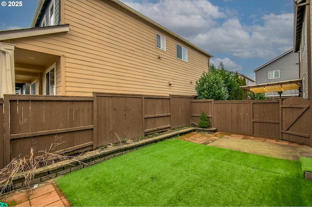 view of yard with fence and a gate