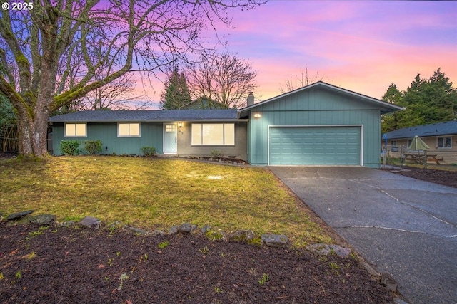 ranch-style house with a front yard, driveway, and an attached garage