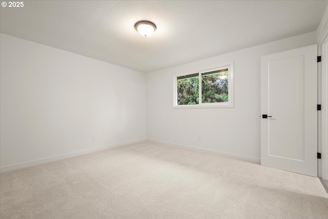 carpeted spare room with baseboards